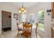 Sunny breakfast nook with large windows offering views of the backyard and a charming dining set at 16126 Hymera Green, Westfield, IN 46074