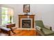 Cozy fireplace with classic mantel, tile surround, and a comfortable seating area in the living room at 16126 Hymera Green, Westfield, IN 46074