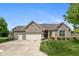 Charming brick ranch home with well-manicured lawn, three-car garage, and inviting front entrance at 16126 Hymera Green, Westfield, IN 46074