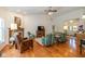 Open-concept living room with hardwood floors, fireplace, and comfortable seating arrangements at 16126 Hymera Green, Westfield, IN 46074