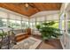 Bright sunroom featuring wood ceiling, many windows with nature view, comfortable seating, and attractive decor at 16126 Hymera Green, Westfield, IN 46074