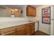 Basement wet bar featuring wooden cabinets, a small fridge, and a Cubs baseball sign at 16126 Hymera Green, Westfield, IN 46074