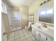 Well-lit bathroom with walk-in shower, white vanity, and tiled floor at 1706 Reverend J.T. Menifee St, Anderson, IN 46016