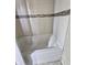Tiled shower and tub with brown accent tiles and a white basin at 1706 Reverend J.T. Menifee St, Anderson, IN 46016