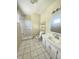 Bright bathroom with white vanity, tiled floors, and a shower at 1706 Reverend J.T. Menifee St, Anderson, IN 46016