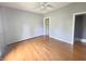 Bedroom with hardwood floors, gray walls, and multiple doorways providing access to other rooms at 1706 Reverend J.T. Menifee St, Anderson, IN 46016