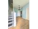 Inviting entryway with beautiful staircase and light hardwood flooring at 1706 Reverend J.T. Menifee St, Anderson, IN 46016