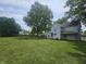 Two-story home with a large yard and mature trees providing shade at 1706 Reverend J.T. Menifee St, Anderson, IN 46016