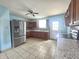 Well-lit kitchen with stainless steel refrigerator, granite countertops, and tiled floor at 1706 Reverend J.T. Menifee St, Anderson, IN 46016