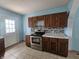 Stainless steel range oven in a kitchen with dark cabinets and granite countertops at 1706 Reverend J.T. Menifee St, Anderson, IN 46016