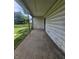 Covered porch with concrete flooring and metal supports on an older home at 1706 Reverend J.T. Menifee St, Anderson, IN 46016