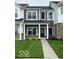 Charming two-story townhouse features a dark door, manicured lawn, and inviting facade at 19450 Northwest Dr, Westfield, IN 46074