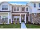 Inviting two-story townhome featuring a cozy front porch and stylish exterior elements at 19450 Northwest Dr, Westfield, IN 46074