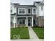 Charming two-story townhouse features a dark door, manicured lawn, and inviting facade at 19450 Northwest Dr, Westfield, IN 46074