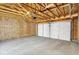 Unfinished garage with a concrete floor, wood framing, and a white garage door at 19450 Northwest Dr, Westfield, IN 46074