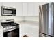 Corner kitchen features stainless steel appliances, white cabinetry, and quartz countertops at 19450 Northwest Dr, Westfield, IN 46074