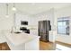 Modern kitchen with stainless steel appliances, stylish lighting, and bright cabinets at 19450 Northwest Dr, Westfield, IN 46074
