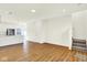 Open-concept living space with hardwood flooring, stairs, and modern white walls at 19450 Northwest Dr, Westfield, IN 46074