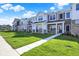 Attractive street view of modern townhomes with sidewalks and lush landscaping at 19450 Northwest Dr, Westfield, IN 46074