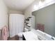 Neutral toned bathroom featuring a shower with a curtain, decorative shelving, and a white countertop at 1972 Rhettsbury St, Carmel, IN 46032
