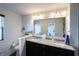 Bathroom with granite countertops, double sinks, and a view into the bedroom at 1972 Rhettsbury St, Carmel, IN 46032