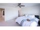 Bright bedroom with fresh white walls features a ceiling fan and comfortable decor at 1972 Rhettsbury St, Carmel, IN 46032