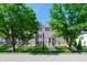Charming townhome with a symmetrical facade, dormer windows, and neatly kept front yard between mature trees at 1972 Rhettsbury St, Carmel, IN 46032