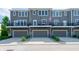 Townhome with three levels, each featuring a balcony, patio, and garage at 1972 Rhettsbury St, Carmel, IN 46032