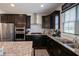 Stylish kitchen with stainless steel appliances, granite counters, gas cooktop, and dark cabinets at 1972 Rhettsbury St, Carmel, IN 46032