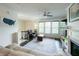 Bright living area featuring a ceiling fan, fireplace, neutral-toned couch, and view of the stairs at 1972 Rhettsbury St, Carmel, IN 46032
