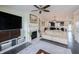 Open living space featuring a white fireplace, large TV, and neutral sofa, blending comfort and functionality at 1972 Rhettsbury St, Carmel, IN 46032