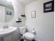 Neat powder room with a vessel sink, round mirror, and decorative wall art at 1972 Rhettsbury St, Carmel, IN 46032