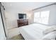 Bright bedroom features carpeted floors, a window for natural light, dresser, and sliding door at 2235 N Kenwood Ave, Indianapolis, IN 46208