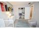 Bright Bedroom features a gray chair, white crib, dresser, and the name 'Theo' displayed on the wall at 2235 N Kenwood Ave, Indianapolis, IN 46208