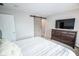 Neutral bedroom features carpeted floors, a window for natural light, barn door, and a dresser at 2235 N Kenwood Ave, Indianapolis, IN 46208