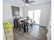 Inviting dining area featuring a rustic table, ample seating, and sliding glass doors to the outside at 2235 N Kenwood Ave, Indianapolis, IN 46208