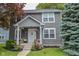 Inviting two-story home with a charming front porch and well-manicured landscaping for curb appeal at 2235 N Kenwood Ave, Indianapolis, IN 46208