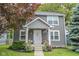 Charming two-story home with a well-maintained front yard and inviting entryway with chairs and decor at 2235 N Kenwood Ave, Indianapolis, IN 46208