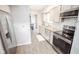 Modern kitchen with stainless steel appliances, ample counter space, and easy access to the dining area at 2235 N Kenwood Ave, Indianapolis, IN 46208
