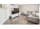 Spacious living room with hardwood floors, a comfortable sofa, and a modern entertainment center at 2235 N Kenwood Ave, Indianapolis, IN 46208