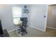 Bright home office featuring a modern chair, an oversized monitor, a window, and carpeted floors at 2235 N Kenwood Ave, Indianapolis, IN 46208