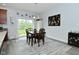 Bright dining area features modern decor, wood table, and a large window at 2330 Oak Dr, Clayton, IN 46118