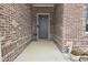 Charming entryway with a gray front door, brick walls, and decorative plants at 2330 Oak Dr, Clayton, IN 46118