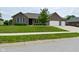 Attractive brick home with a well-kept lawn, a two-car garage, and mature trees at 2330 Oak Dr, Clayton, IN 46118