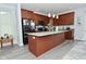 Modern kitchen with a large island, granite countertops, and dark wood cabinets at 2330 Oak Dr, Clayton, IN 46118