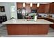 Spacious kitchen featuring a center island with granite countertops and pendant lighting at 2330 Oak Dr, Clayton, IN 46118