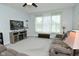 Cozy living room with plush seating, a ceiling fan, and a large window at 2330 Oak Dr, Clayton, IN 46118