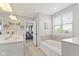 Bright bathroom featuring a tub, tile accents, double sinks and an open doorway at 2447 Stonehaven Dr, Avon, IN 46123