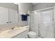 Bright bathroom features a glass enclosed shower, white cabinets and countertop, and modern fixtures at 2447 Stonehaven Dr, Avon, IN 46123