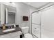 Clean bathroom featuring a glass enclosed shower, modern fixtures, and vanity storage at 2447 Stonehaven Dr, Avon, IN 46123